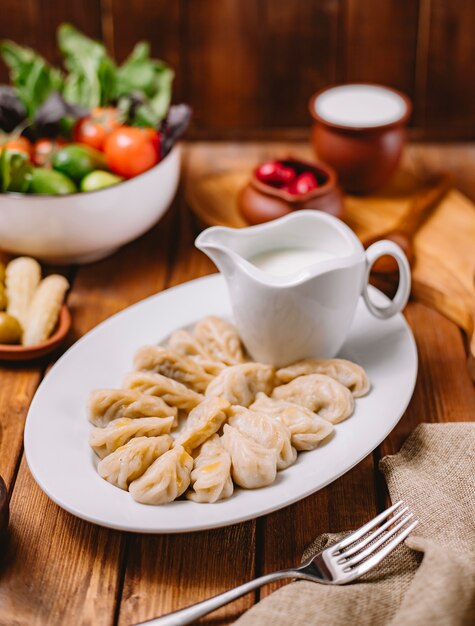 Gurza dumplings platter served with yogurt