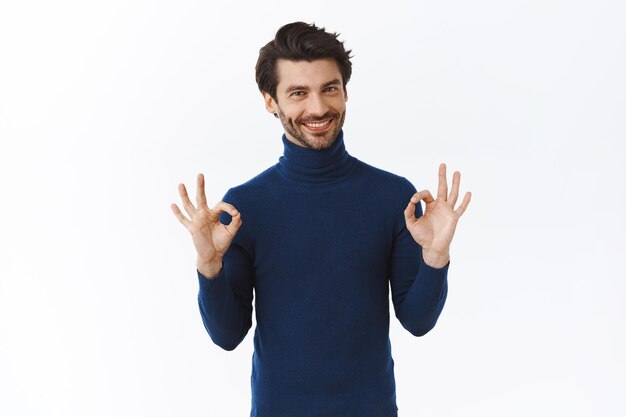 guy in blue high neck sweater, say everything alright, showing okay, acceptance or agree gesture, smiling nod in approval