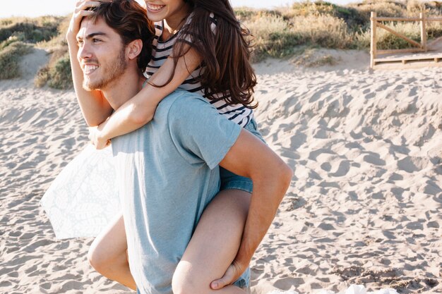 Guy carrying girl at the beach