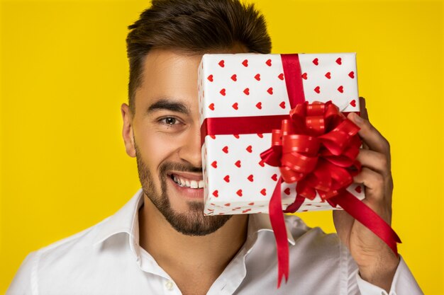 The guy closed part of his face by a present