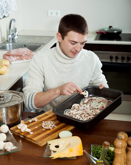 Guy cooking french-style meat