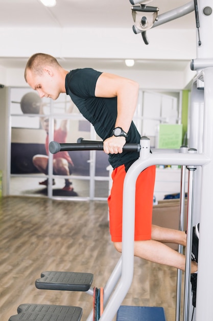 Guy doing exercise in gym