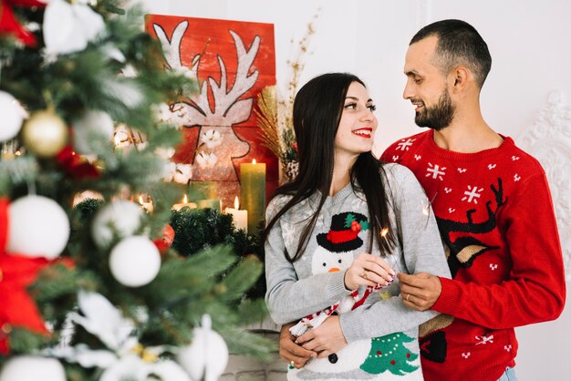 Guy embracing lady near fireplace