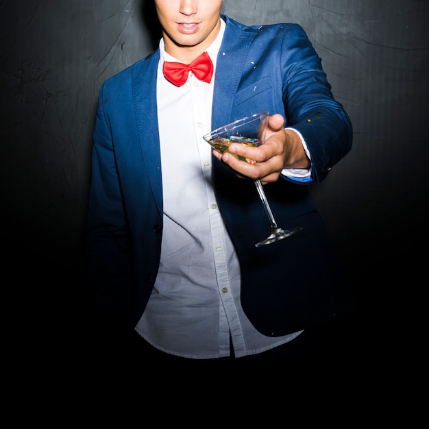 Free photo guy in evening jacket with glass of drink