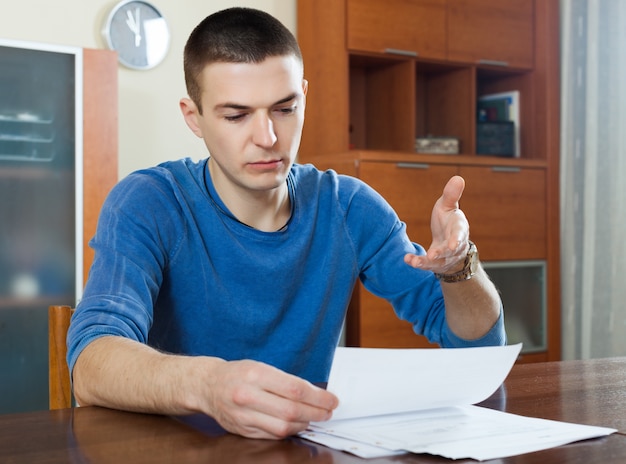 Free photo guy fills in financial documents