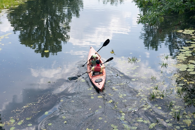 A guy and a girl canoe paddling the river