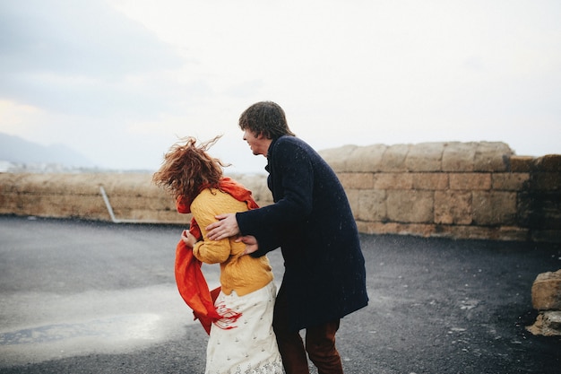 Free photo guy and girl have fun  in the rain