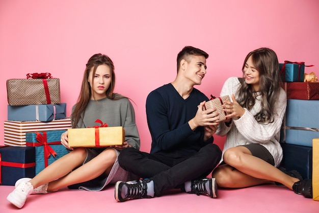 Guy giving christmas gift box to girl.