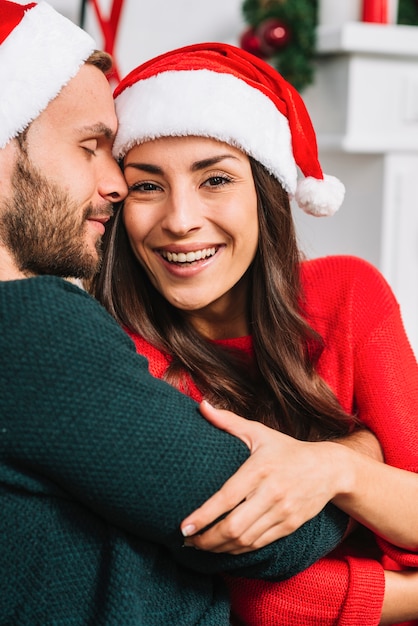 Guy hugging lady in party hat