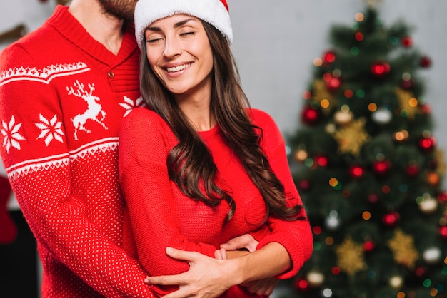 Guy hugging smiling lady with closed eyes