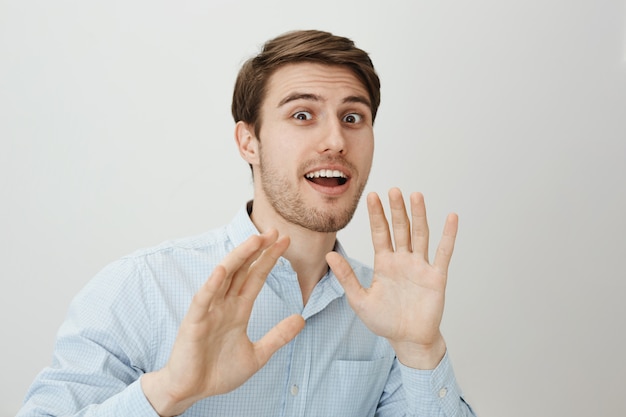 Guy raising hands up defensive as someone attack him