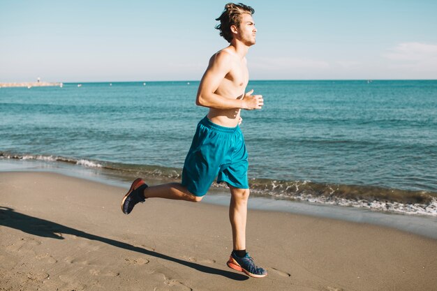 Guy running at the beach