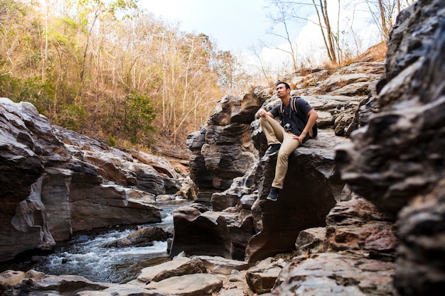 Guy sitting at river