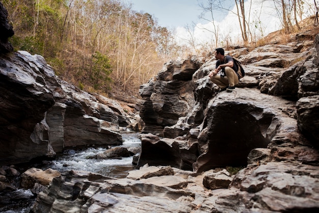 Guy sitting at wild river