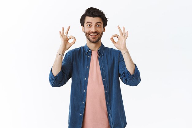 Guy thinks your choice perfect giving approval Impressed goodlooking bearded man showing okay ok or good gesture smiling and nod in agreement support and like idea white background
