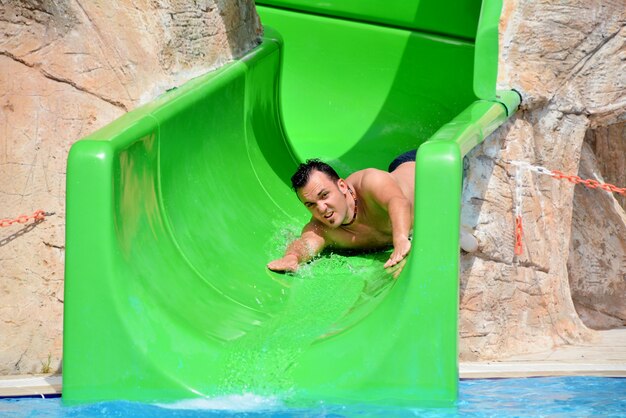 Guy on water slide during summer holiday