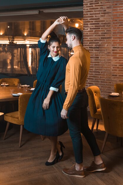 Guy whirling charming lady in restaurant