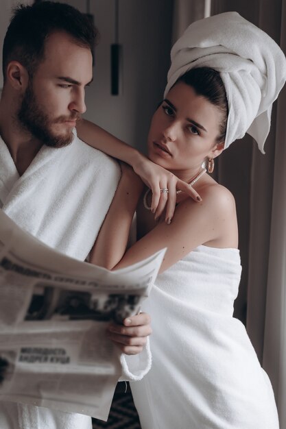 Guy in a white coat and a woman in a towel