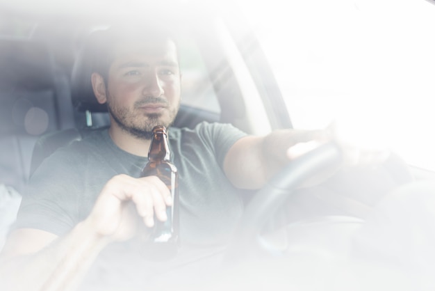 Guy with booze driving car