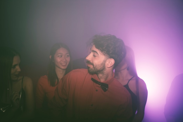 Guy with girls in nightclub