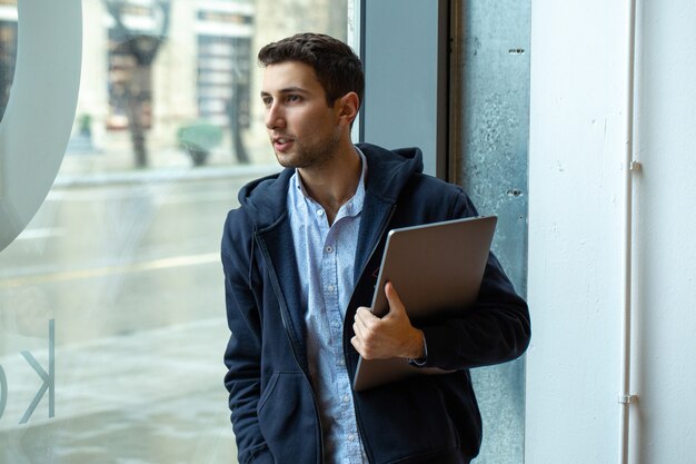 A guy with laptop in his hands