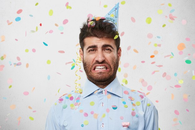 Guy with party hat and confetti