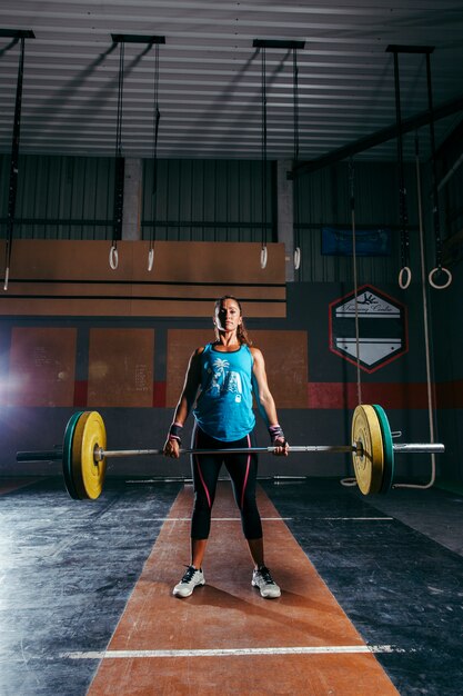 Gym concept with woman lifting barbell