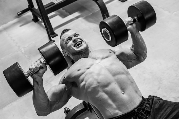 Gym. Handsome man during workout