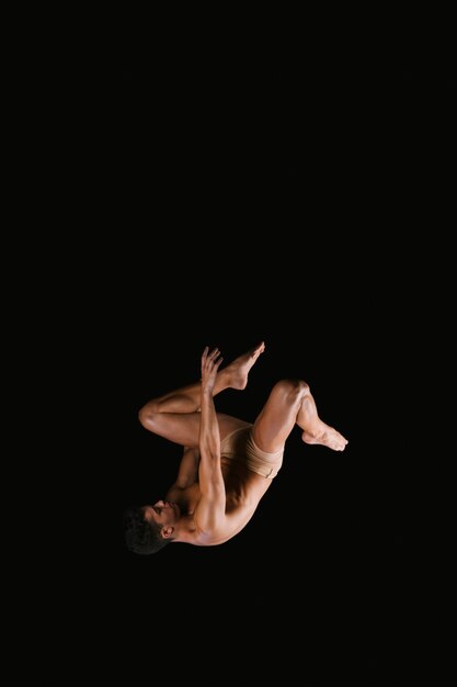 Gymnast doing somersault exercise in air