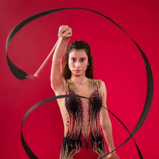 Gymnast making positions with the ribbon