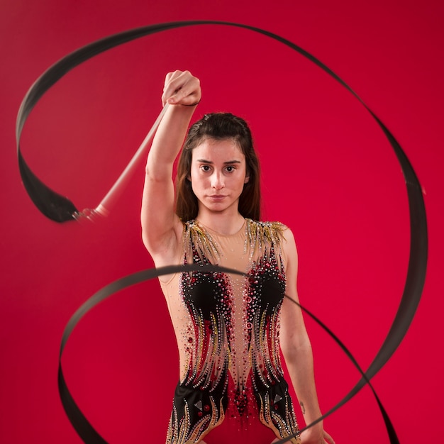 Gymnast making positions with the ribbon