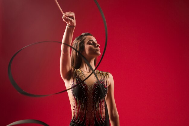 Gymnast making positions with the ribbon