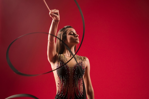 Gymnast making positions with the ribbon