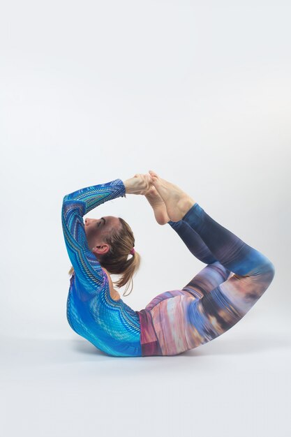 Gymnast in a multi-colored tights during training