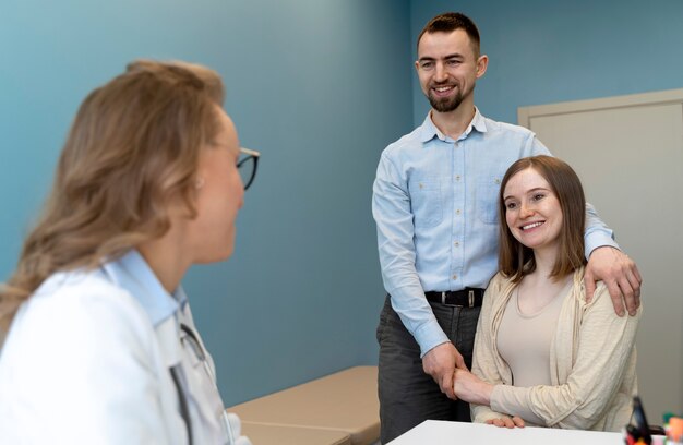 Gynecologist evaluating pregnancy with patient