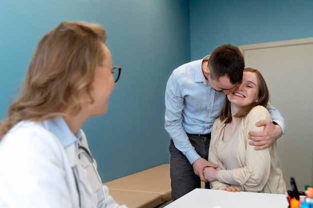 Gynecologist evaluating pregnancy with patient