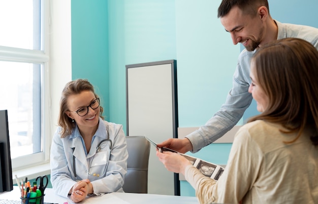 Gynecologist evaluating pregnancy with patient