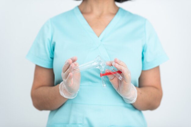 A gynecologist holds a gynecological mirror in his hands before examining a patient medicine