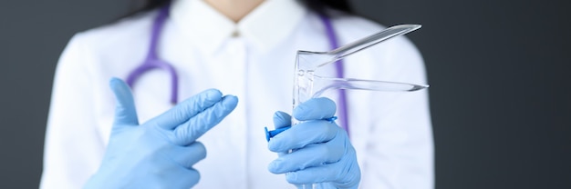 Gynecologist holds an instrument for examining women gynecological examination concept