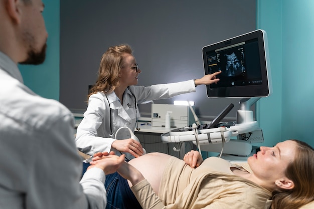 Free Photo gynecologist performing ultrasound consultation