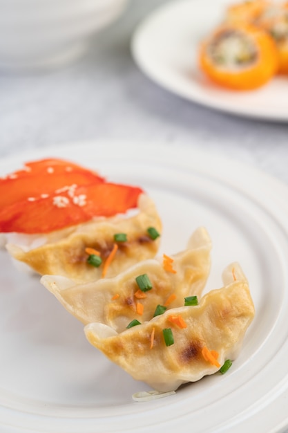 Gyoza in a white dish.