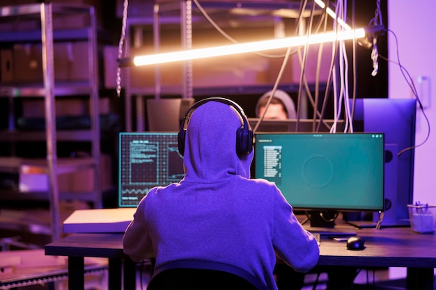 Free photo hacker in headphones breaching data