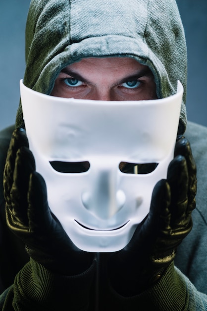 Hacker holding mask