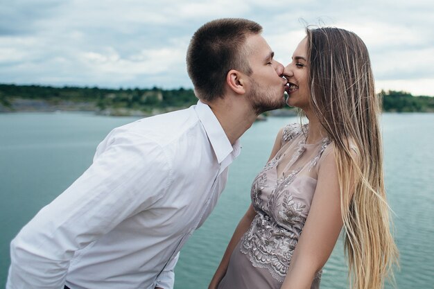 The hadsome boy kissing his girlfriend