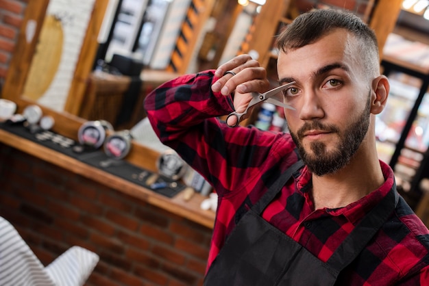 Free photo haidresser showing his scissors