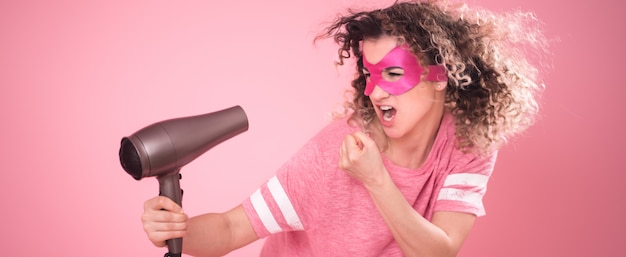 Free photo hair care, cute woman with hair dryer in hand