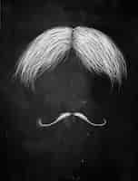 Free photo hair and curly mustache on blackboard