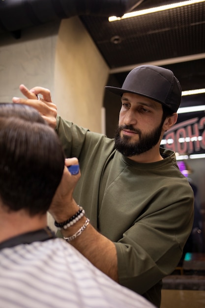 Hairdresser cutting a man's hair at the barber shop