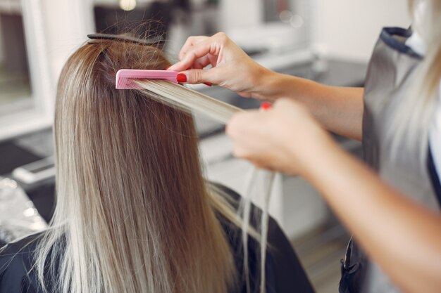 Hairdresser does hairstyle for her client