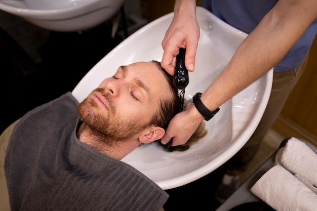 Free photo hairdresser grooming their client